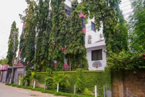 a building with ivy on the side of a street at S&J Luxury Homes Mombasa in Mombasa