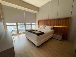 a bedroom with a bed and a large window at Premium Taman Anggrek Residences in Jakarta +52 photos