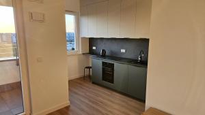 a kitchen with a sink and a counter top at Bemowo Apartment in Warsaw +4 photos