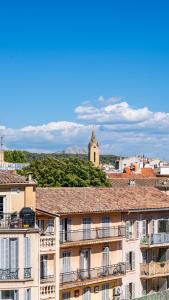 a view of a city with buildings and a church at Hôtel Saint Christophe Aix en Provence Centre Ville by Germain Collection in Aix-en-Provence +36 photos