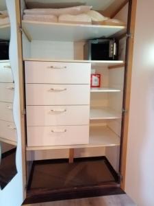 a closet with white drawers and shelves at Begonie in Siegsdorf +38 photos