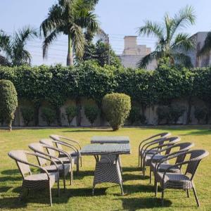 a row of tables and chairs in a field at Dreamanor Blissful Stay Amritsar in Amritsar +48 photos