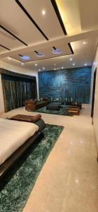 a bedroom with two beds and a room with a tub at Dreamanor Blissful Stay Amritsar in Amritsar