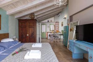 a room with a bed and a tv and a kitchen at Tiny House With Private Pool Kostrena - Happy Rentals in Kostrena