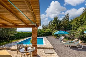 a patio with a table and chairs and a swimming pool at Tiny House With Private Pool Kostrena - Happy Rentals in Kostrena +22 photos
