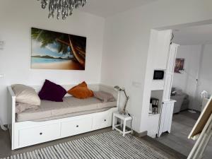 a white room with a bed with pillows on it at Finca Seño Donato Lomo La Santa in Tinajo