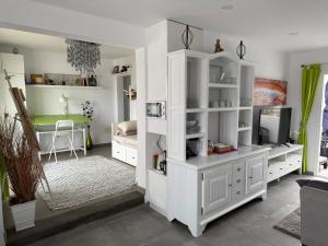 a living room with white furniture and a table at Finca Seño Donato Lomo La Santa in Tinajo