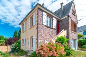 プレヌフ・ヴァル・アンドレにあるMaison Hortense - à Pléneuf-Val-Andréの赤い扉のあるレンガ造りの家