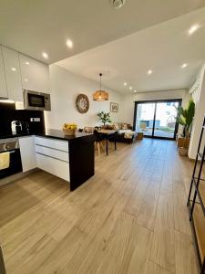a large kitchen and living room with a table at Casa Mia in Torrevieja