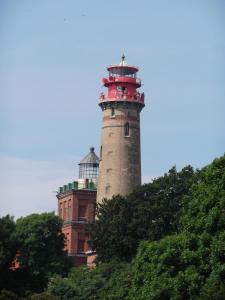 a lighthouse sitting on top of a building at Ferienwohnung auf Rügen ganz oben in Putgarten