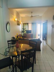 a dining room and living room with a table and chairs at Oceanwhite Homestay Corus in Port Dickson