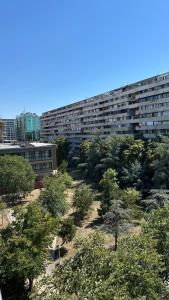a large building with trees in front of it at Green apartment arena-usce in Belgrade