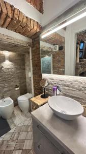 a bathroom with a sink and a toilet in it at Casa Area in Somma Lombardo +13 photos