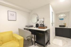 a room with a desk and a chair and a mirror at Arentz Hotel in Anyang
