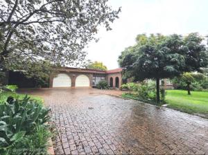 a brick driveway in front of a house at Flora Gardens guest house in Vanderbijlpark
