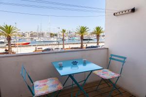 a table and two chairs on a balcony with a view of a harbor at Marina Mirror Harbour in Lagos