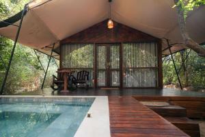 a house with a swimming pool and a tent at Tribe Yala - Luxury Camping in Yala
