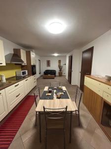 a kitchen with a table and chairs in a room at Villa Penelope in Bollate +5 photos