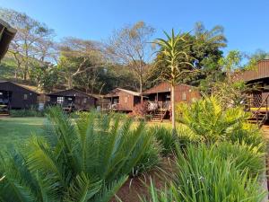 a view of a resort with palm trees and houses at Pleasant Waters Lodge & Conference Venue in Durban
