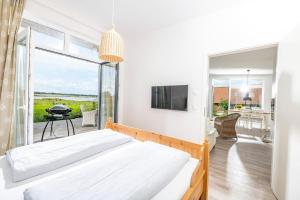 a bedroom with a bed and a large window at Insel in Gelting