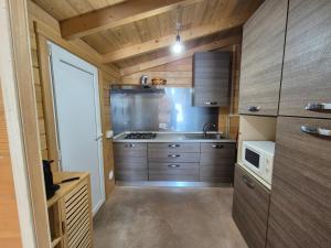 a small kitchen with a sink and a stove at La Casetta in San Vincenzo