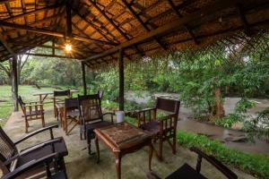 a group of chairs and tables under a roof at WildEscape, Yala Blocks 3, 4 & 5 in Buttala