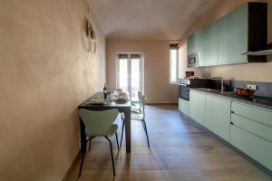 a kitchen with a table and chairs in a room at La Volta in Cuneo
