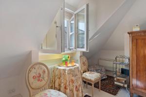 a room with a table and chairs and a window at Attico Palazzo Giustiniani in Genova