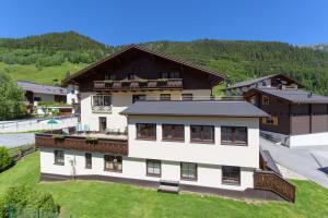a large white building with a mountain in the background at Haus Morgensonne in Sankt Anton am Arlberg