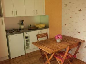a kitchen with a wooden table and a table and chairs at Cozy chalet in Ponchel with pond in Le Ponchel