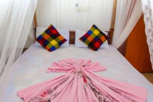 Postel nebo postele na pokoji v ubytování Pearl Deluna Resort Mirissa