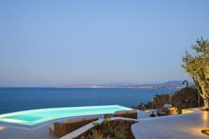 a swimming pool with a view of the water at In Blue Villa, Sea View Reverie with a Secluded Beach by etouri in Heraklio Town