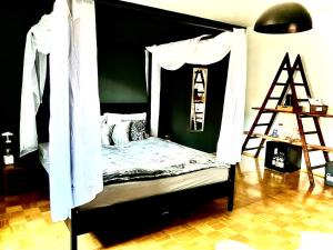 a bedroom with a canopy bed with a ladder at Adlershof in Hemmersheim