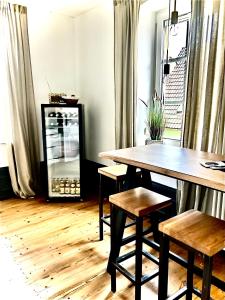 a dining room with a table and chairs and a window at Adlershof in Hemmersheim