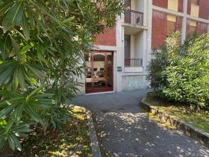 an entrance to a building with a red door at Casa Luna in Mandello del Lario
