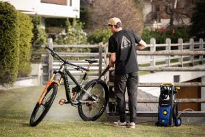 a man is standing next to a bike at Ride Inn Verbier - B&B - private small twin room, shared bathrooms in Verbier