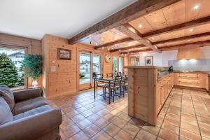 a kitchen and living room with a couch and a table at Ride Inn Verbier - B&B - private small twin room, shared bathrooms in Verbier