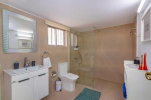 a bathroom with a shower and a toilet and a sink at Two Bedroom Garden Cottage in Quiet Street in Limassol +36 photos