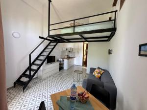 a living room with a couch and a loft bed at El Hierro in Ingenio