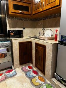 a kitchen with mats on the floor of a kitchen at Golden Suit in Dakar +10 photos