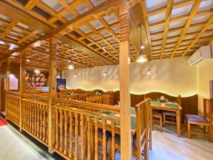 a dining room with wooden beams and a table at HotelInsta in Kathmandu