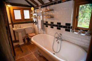 a bathroom with a tub and a toilet and a sink at Ye Olde Cottage in Crawley +27 photos