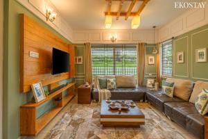a living room with a couch and a table at EKO STAY - Woodside Ivy in Ooty