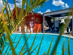 a pool in front of a house at Apartment Sova or Deluxe room 33 in Bled