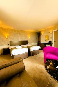 a hotel room with two beds and a couch at Claremont Hotel - All Inclusive! in Blackpool +57 photos