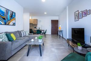 a living room with a couch and a table at Invictus 2-Bedroom Apartment in Larnaca