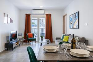 a living room with a table and a couch at Invictus 2-Bedroom Apartment in Larnaca