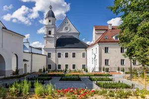 Domus Maria — A building with a clock tower and a garden