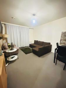a living room with a couch and a table at One Bedroom Apartment Barking in Barking
