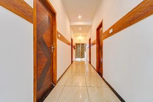 an empty corridor with a door and a hallway at FabHotel Raja Residency in Alāndurai